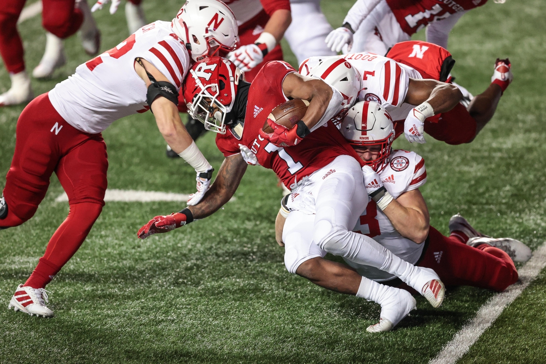 Dec 18, 2020; Piscataway, New Jersey, USA; Rutgers Scarlet Knights running back Isaih Pacheco (1) carries the ball as Nebraska Cornhuskers linebacker Nick Henrich (42) and linebacker Will Honas (3) tackle during the first half at SHI Stadium. Mandatory Credit: Vincent Carchietta-USA TODAY Sports