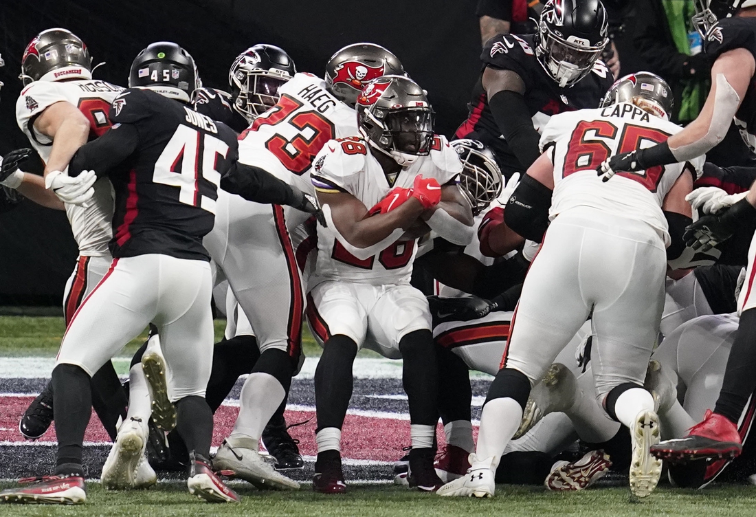 Dec 20, 2020; Atlanta, Georgia, USA; Tampa Bay Buccaneers running back Leonard Fournette (28) scores a touchdown against the Atlanta Falcons in the second half of a NFL game at Mercedes-Benz Stadium. Mandatory Credit: Dale Zanine-USA TODAY Sports
