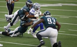 Dec 27, 2020; Arlington, Texas, USA; Dallas Cowboys quarterback Andy Dalton (14) is sacked by Philadelphia Eagles offensive tackle Andre Dillard (77) and defensive end Brandon Graham (55) in the first quarter at AT&T Stadium. Mandatory Credit: Tim Heitman-USA TODAY Sports