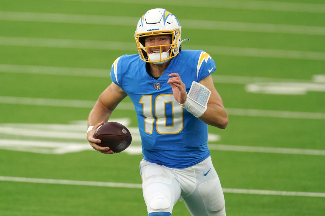 Dec 27, 2020; Inglewood, California, USA; Los Angeles Chargers quarterback Justin Herbert (10) runs with the ball against the Denver Broncos in the third quarter at SoFi Stadium. Mandatory Credit: Kirby Lee-USA TODAY Sports
