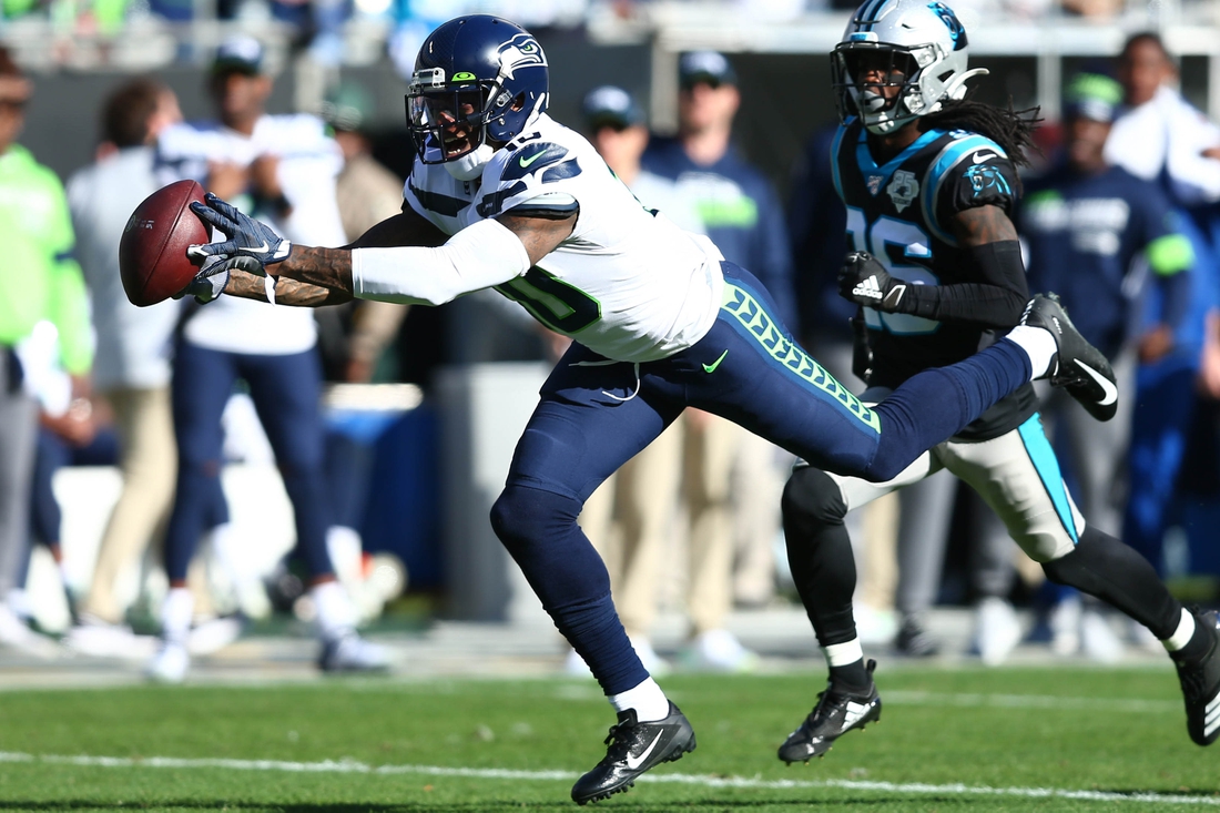 Dec 15, 2019; Charlotte, NC, USA; Seattle Seahawks wide receiver Josh Gordon (10) catches a pass against Carolina Panthers cornerback Donte Jackson (26) during the second quarter at Bank of America Stadium. Mandatory Credit: Jeremy Brevard-USA TODAY Sports