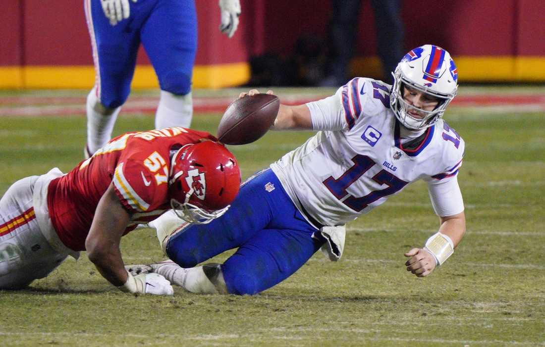 Jan 24, 2021; Kansas City, MO, USA; Buffalo Bills quarterback Josh Allen (17) is tackled by Kansas City Chiefs defensive end Alex Okafor (57) during the fourth quarter in the AFC Championship Game at Arrowhead Stadium. Mandatory Credit: Denny Medley-USA TODAY Sports