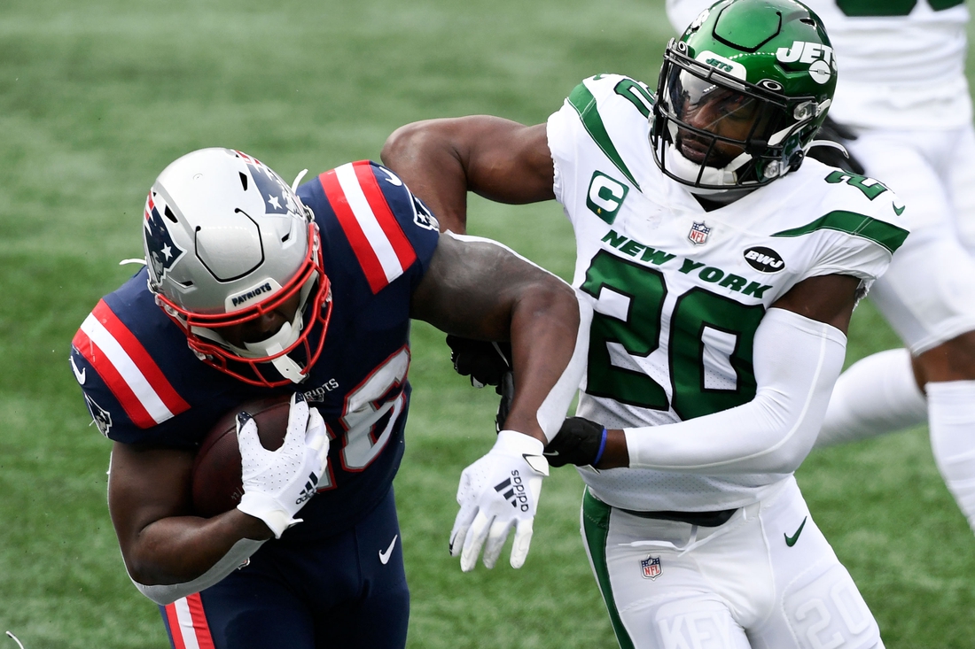 Jan 3, 2021; Foxborough, Massachusetts, USA; New England Patriots running back Sony Michel (26) rushes against New York Jets free safety Marcus Maye (20) during the first quarter at Gillette Stadium. Mandatory Credit: Brian Fluharty-USA TODAY Sports