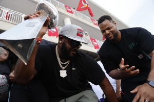 Feb 10, 2021; Tampa Bay, FL, USA;  Tampa Bay Buccaneers offensive tackle Donovan Smith (left) and defensive end Ndamukong Suh dance with the Vince Lombardi Trophy during a boat parade to celebrate victory in Super Bowl LV against the Kansas City Chiefs. Mandatory Credit: Kim Klement-USA TODAY Sports