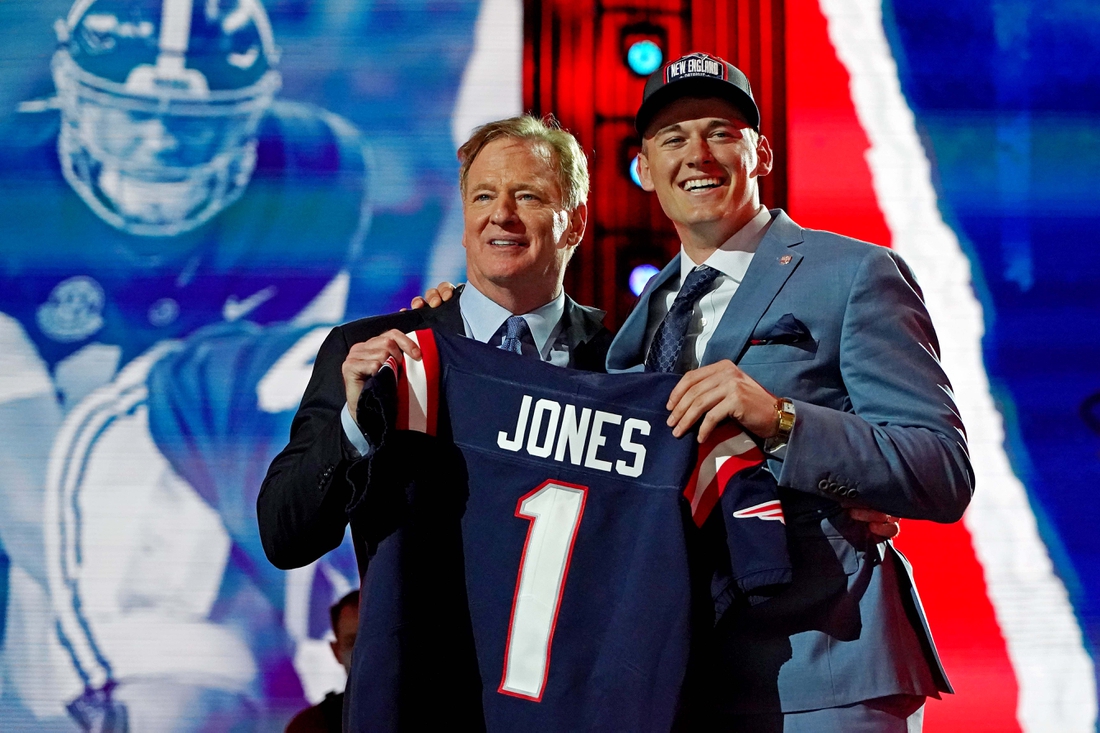 Apr 29, 2021; Cleveland, Ohio, USA; Mac Jones (Alabama) with NFL commissioner Roger Goodell after being selected by the New England Patriots as the number 15 overall pick in the first round of the 2021 NFL Draft at First Energy Stadium. Mandatory Credit: Kirby Lee-USA TODAY Sports