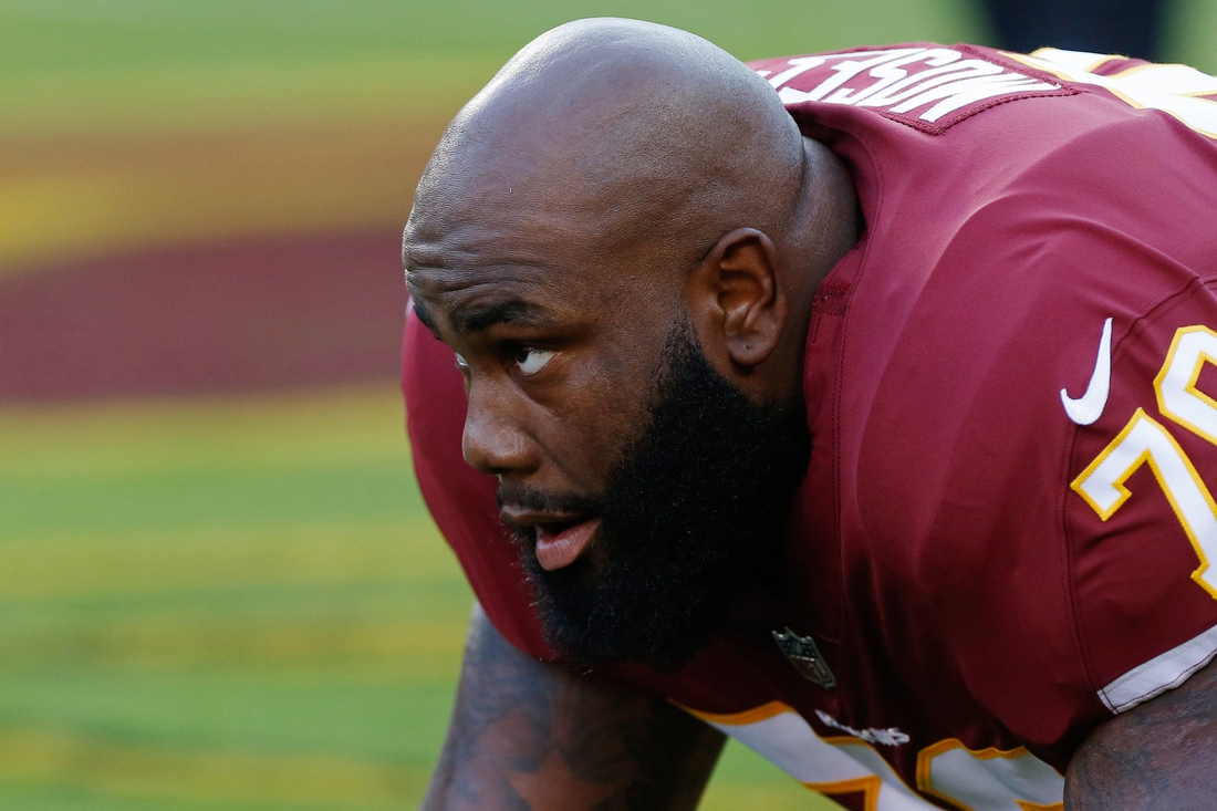 Aug 24, 2018; Landover, MD, USA; Washington Redskins offensive tackle Morgan Moses (76) stretches during warm-ups prior to the Redskins' game against the Denver Broncos at FedEx Field. Mandatory Credit: Geoff Burke-USA TODAY Sports