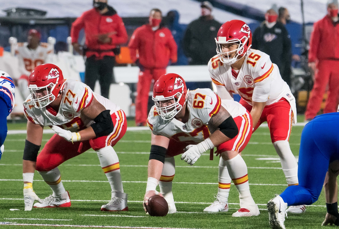 Oct 19, 2020; Orchard Park, New York, USA; Kansas City Chiefs quarterback Patrick Mahomes (15) with center Daniel Kilgore (67) and offensive guard Andrew Wylie (77) at the line of scrimmage against the Buffalo Bills in the third quarter at  Bills Stadium. Mandatory Credit: Mark Konezny-USA TODAY Sports