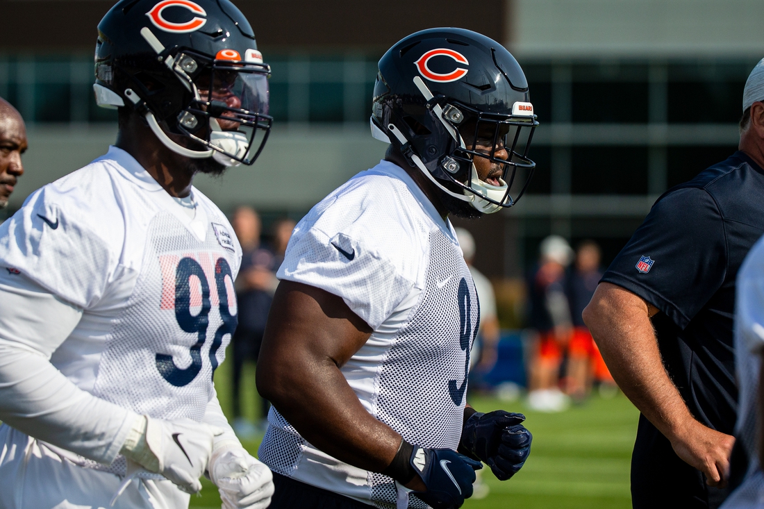 Jul 29, 2021; Lake Forest, IL, USA; Chicago Bears nose tackle Eddie Goldman (91) runs a lap around the field at the start of a Chicago Bears training camp session at Halas Hall. Mandatory Credit: Jon Durr-USA TODAY Sports