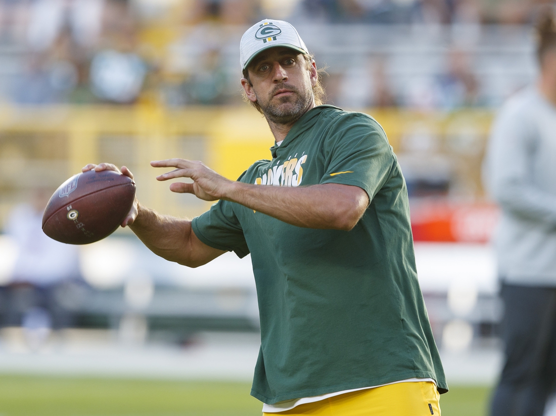 Aug 14, 2021; Green Bay, Wisconsin, USA;  Green Bay Packers quarterback Aaron Rodgers throws a pass during warmups prior to a game against the  Houston Texans at Lambeau Field. Mandatory Credit: Jeff Hanisch-USA TODAY Sports