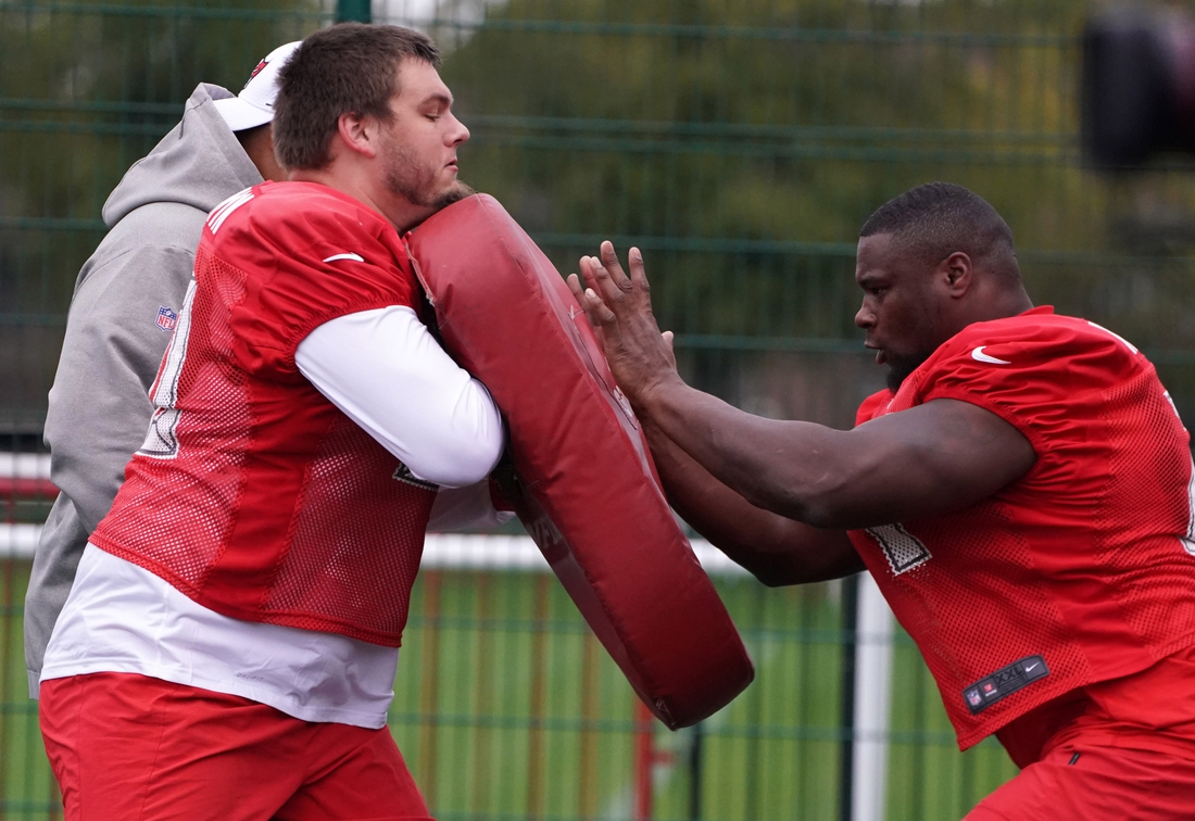 Oct 11, 2019; London, United Kingdom; Tampa Bay Buccaneers Nate Trewyn (60) and offensive guard Earl Watford (71) participate in blocking drills  during practice at the Blackheath Rugby Club. Mandatory Credit: Kirby Lee-USA TODAY Sports