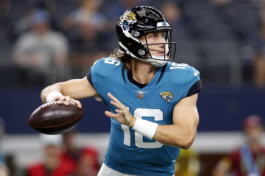 Aug 29, 2021; Arlington, Texas, USA; Jacksonville Jaguars quarterback Trevor Lawrence (16) rolls out to throw a pass in the first quarter against the Dallas Cowboys at AT&T Stadium. Mandatory Credit: Tim Heitman-USA TODAY Sports