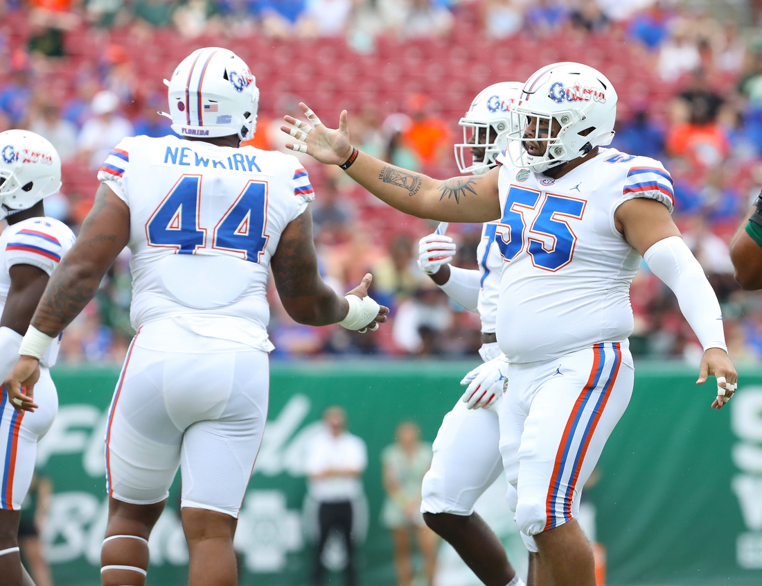 Florida Gators defensive lineman Antonio Valentino (55) congratulates Florida Gators defensive lineman Daquan Newkirk (44) after a big stop during the second game of the season against the USF Bulls at Raymond James Stadium, in Tampa Fla. Sept. 11, 2021.

Flgai 09112021 Ufvs Usf Action32