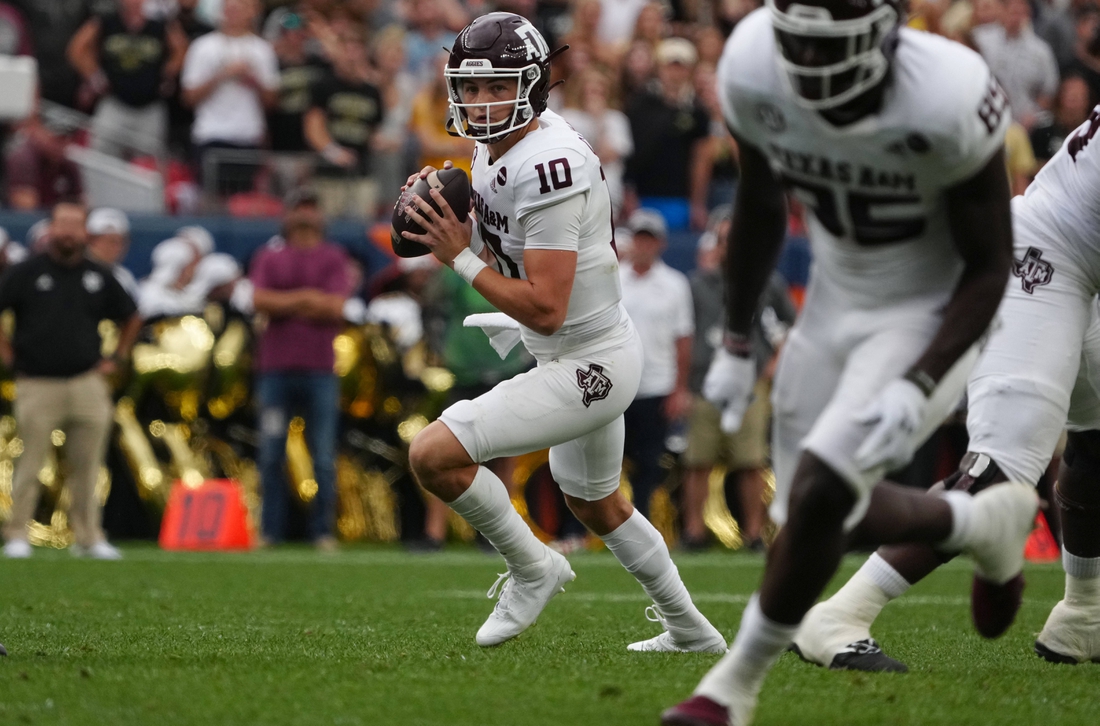 Sep 11, 2021; Denver, Colorado, USA; Texas A&M Aggies quarterback Zach Calzada (10) looks to pass in the second quarter against the Colorado Buffaloes  at Empower Field at Mile High. Mandatory Credit: Ron Chenoy-USA TODAY Sports