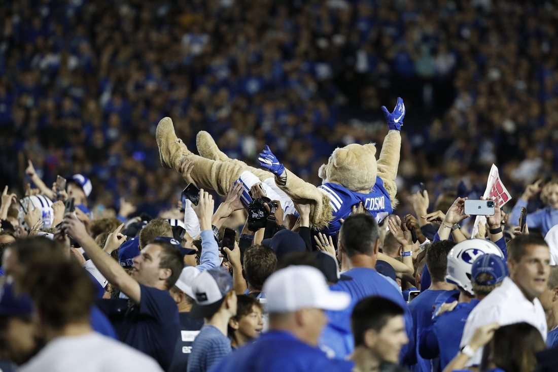 Sep 11, 2021; Provo, Utah, USA; Brigham Young Cougars mascot Cosmo body surfs as fans stormed the field after their win over the Utah Utes at LaVell Edwards Stadium. Mandatory Credit: Jeffrey Swinger-USA TODAY Sports