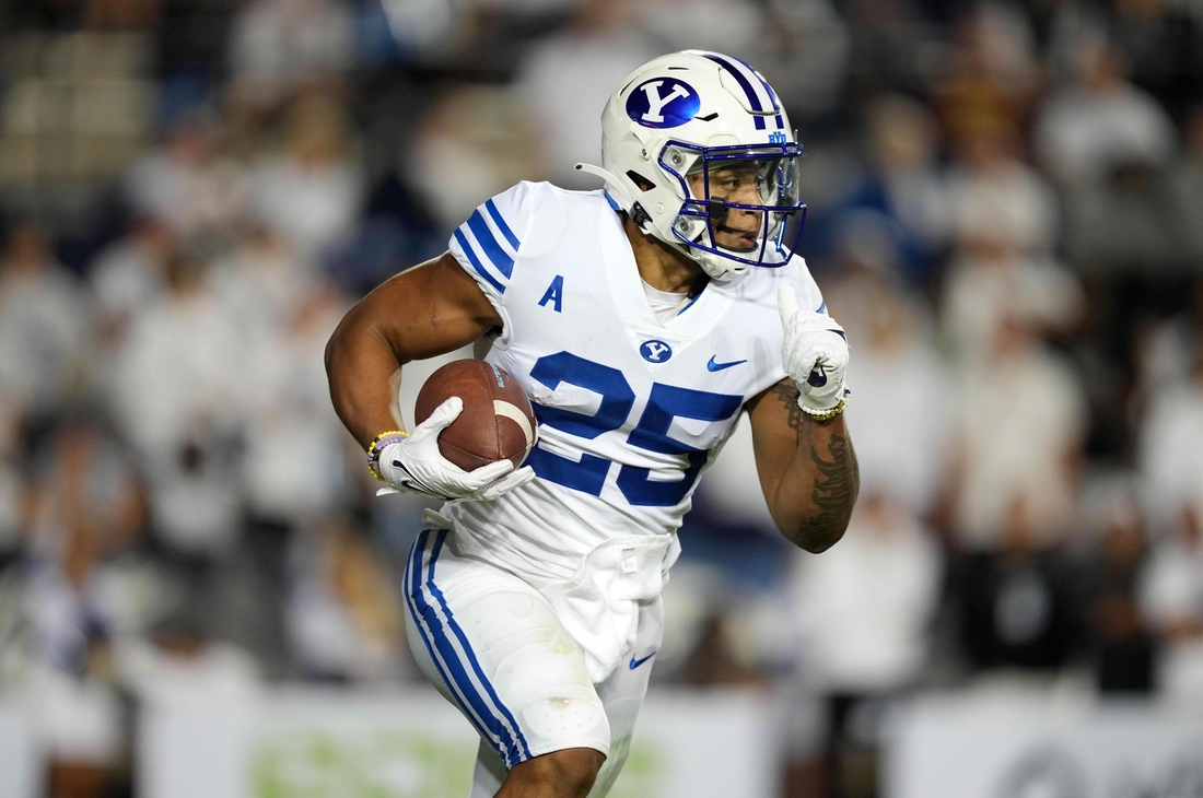 Sep 18, 2021; Provo, Utah, USA; BYU Cougars running back Tyler Allgeier (25) carries the ball in the first quarter against the Arizona State Sun Devils at LaVell Edwards Stadium. Mandatory Credit: Kirby Lee-USA TODAY Sports