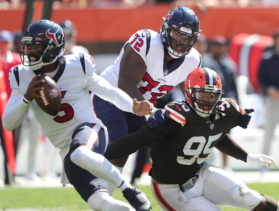 Cleveland Browns defensive end Myles Garrett (95) is held by Houston Texans offensive tackle Geron Christian (72) as he rushes Houston Texans quarterback Tyrod Taylor (5) during the first half of an NFL football game, Sunday, Sept. 19, 2021, in Cleveland, Ohio. [Jeff Lange/Beacon Journal]

Browns 6