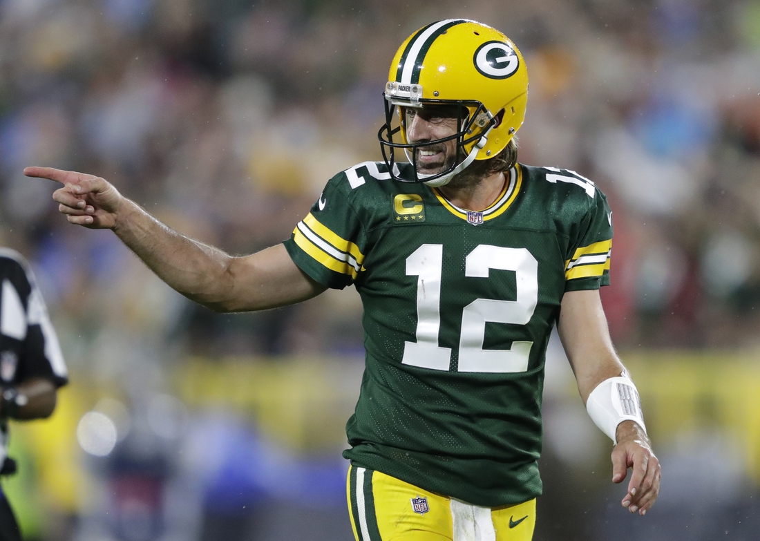 Sep 20, 2021; Green Bay, WIsconsin, USA; Green Bay Packers quarterback Aaron Rodgers (12) celebrates after a pass completion to wide receiver Davante Adams (not pictured) against the Detroit Lions at Lambeau Field. Mandatory Credit: Dan Powers/Appleton Post-Crescent via USA TODAY NETWORK