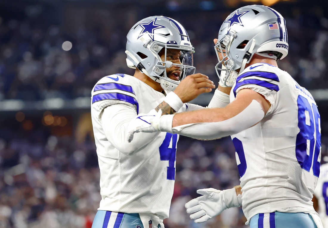 Sep 27, 2021; Arlington, Texas, USA; Dallas Cowboys quarterback Dak Prescott (4) celebrates with wide receiver CeeDee Lamb (88) after a touchdown pass against the Philadelphia Eagles during the first quarter at AT&T Stadium. Mandatory Credit: Kevin Jairaj-USA TODAY Sports