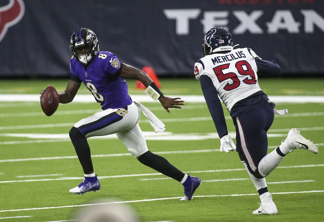Sep 20, 2020; Houston, Texas, USA; Baltimore Ravens quarterback Lamar Jackson (8) rolls out of the pocket with the ball as Houston Texans outside linebacker Whitney Mercilus (59) applies defensive pressure during the second quarter at NRG Stadium. Mandatory Credit: Troy Taormina-USA TODAY Sports