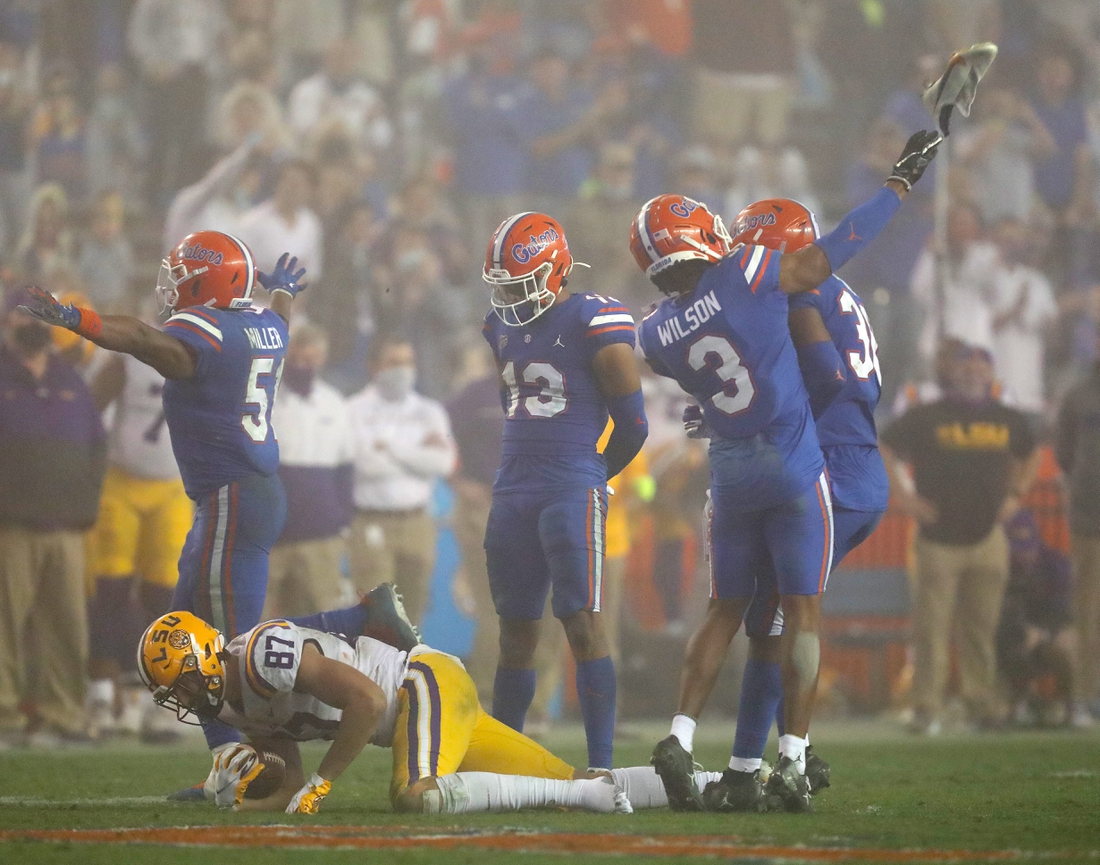 After a tackle Florida Gators defensive back Marco Wilson (3) throws the shoe of LSU tight end Kole Taylor (87) which resulted in a personal foul penalty against Wilson, during a game against the LSU Tigers at Ben Hill Griffin Stadium in Gainesville, Fla. Dec. 12, 2020. Florida lost 37-34 to the Tigers.

Sports Mcclenny02