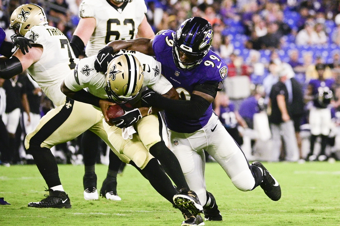Aug 14, 2021; Baltimore, Maryland, USA; Baltimore Ravens linebacker Odafe Oweh (99) leaps to sack New Orleans Saints quarterback Jameis Winston (2) during the first half  at M&T Bank Stadium. Mandatory Credit: Tommy Gilligan-USA TODAY Sports