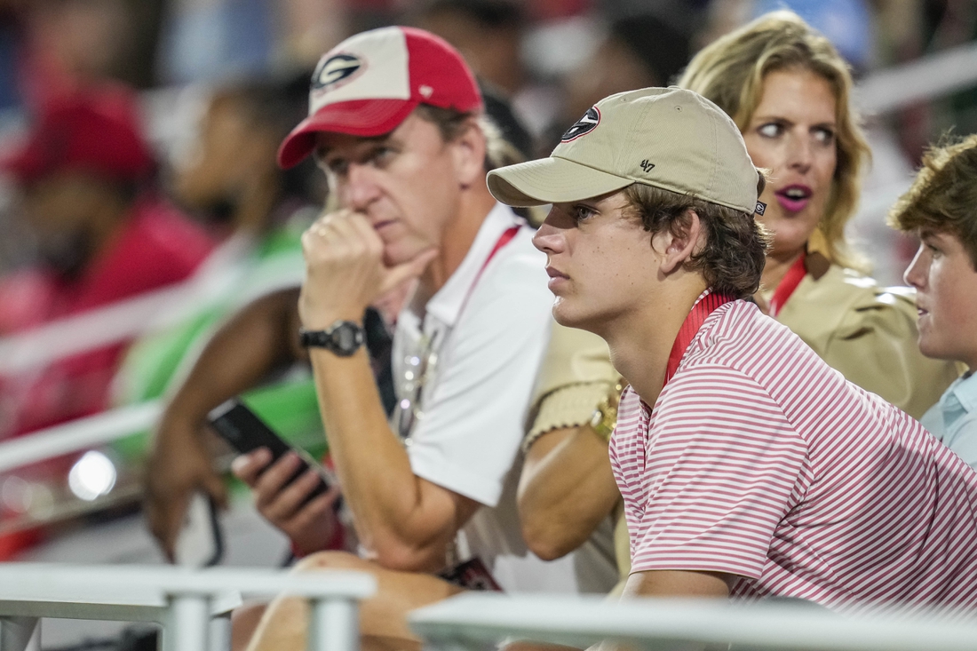 Sep 18, 2021; Athens, Georgia, USA; High school player Arch Manning looks on with his parents during a game between the South Carolina Gamecocks against the Georgia Bulldogs at Sanford Stadium. Mandatory Credit: Dale Zanine-USA TODAY Sports