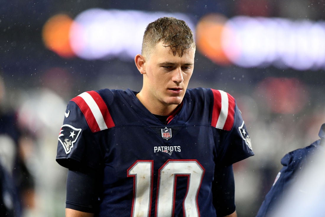 Oct 3, 2021; Foxborough, Massachusetts, USA; New England Patriots quarterback Mac Jones (10) walks off of the field after a loss to the Tampa Bay Buccaneers at Gillette Stadium. Mandatory Credit: Brian Fluharty-USA TODAY Sports