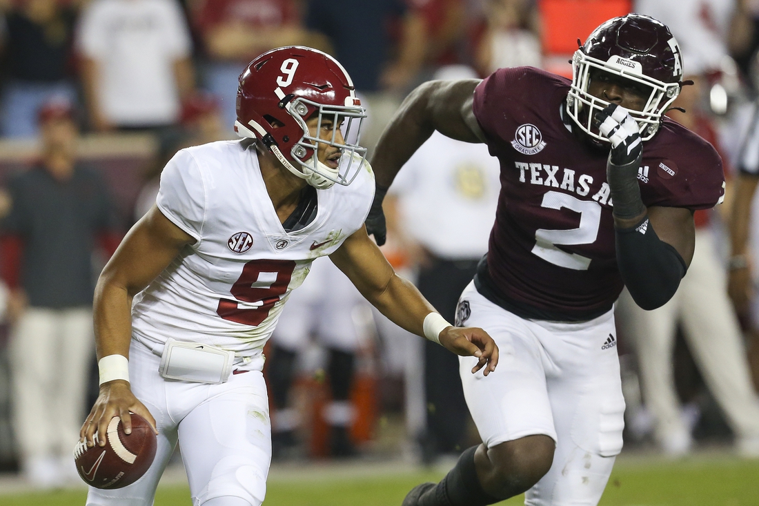 Oct 9, 2021; College Station, Texas, USA; Alabama Crimson Tide quarterback Bryce Young (9) is chased by Texas A&M Aggies defensive lineman Micheal Clemons (2) in the first quarter at Kyle Field. Mandatory Credit: Thomas Shea-USA TODAY Sports