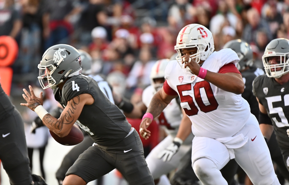 Oct 16, 2021; Pullman, Washington, USA; Washington State Cougars quarterback Jayden de Laura (4) is chased out of the pocket by Stanford Cardinal defensive tackle Dalyn Wade-Perry (50) in the first half at Gesa Field at Martin Stadium. Mandatory Credit: James Snook-USA TODAY Sports
