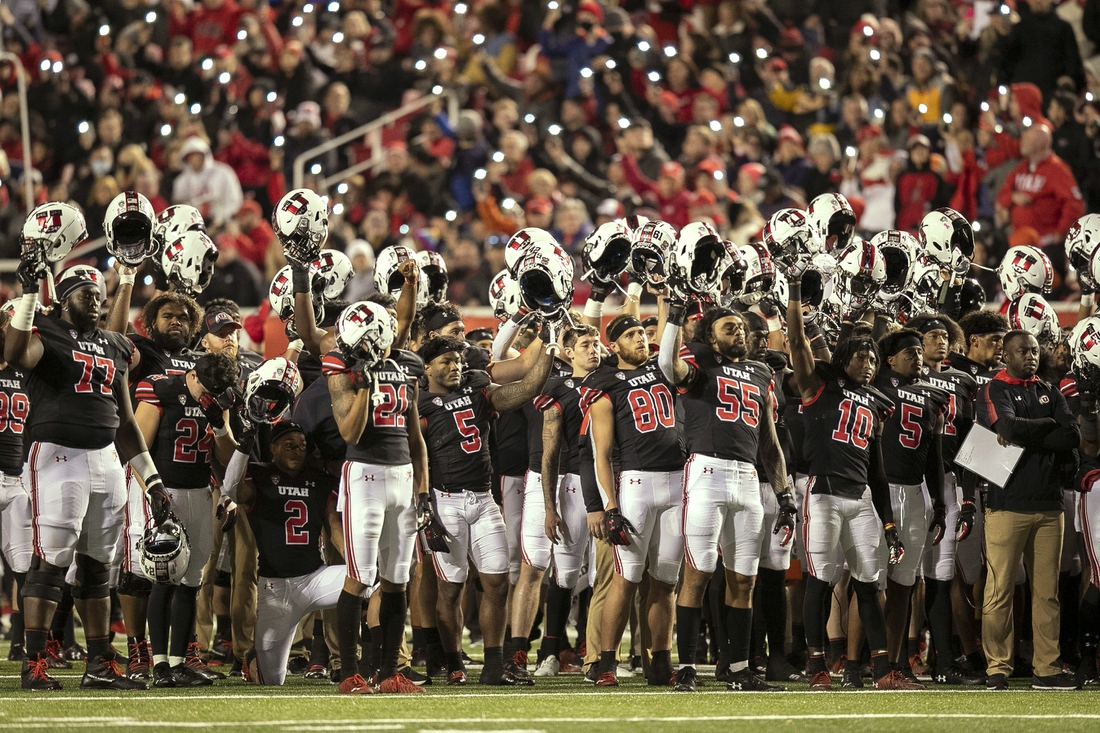 Oct 16, 2021; Salt Lake City, Utah, USA;  Utah Utes players raise their helmets and cheer during the fourth quarter break in a tribute to Aaron Lowe and Ty Jordan in a game against the Arizona State Sun Devils at Rice-Eccles Stadium. Mandatory Credit: Rob Gray-USA TODAY Sports