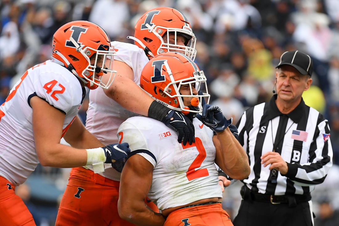 Oct 23, 2021; University Park, Pennsylvania, USA; Illinois Fighting Illini running back Chase Brown (2) celebrates his touchdown run with teammates against the Penn State Nittany Lions during the first half at Beaver Stadium. Mandatory Credit: Rich Barnes-USA TODAY Sports
