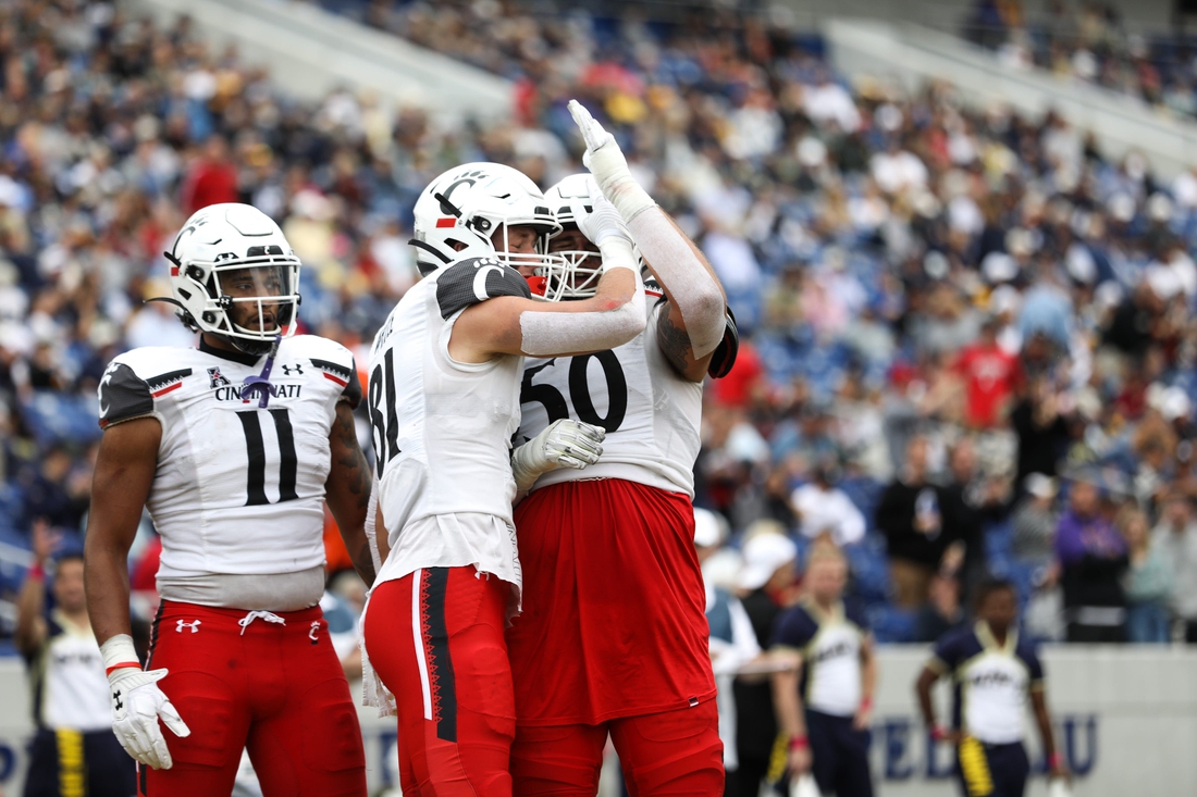 UC's Josh Whyle (81) celebrates with the team after scoring another touchdown during the second half of the UC Bearcat vs. Navy Midshipmen game at Navy-Marine Corps Memorial Stadium on Saturday October 23, 2021. UC won the game with a final score of 27-20.