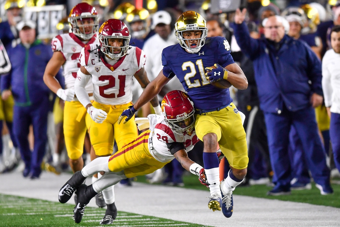 Oct 23, 2021; South Bend, Indiana, USA; Notre Dame Fighting Irish wide receiver Lorenzo Styles Jr. (21) runs the ball as USC Trojans safety Xavion Alford (29) attempts to tackle in the second quarter at Notre Dame Stadium. Mandatory Credit: Matt Cashore-USA TODAY Sports