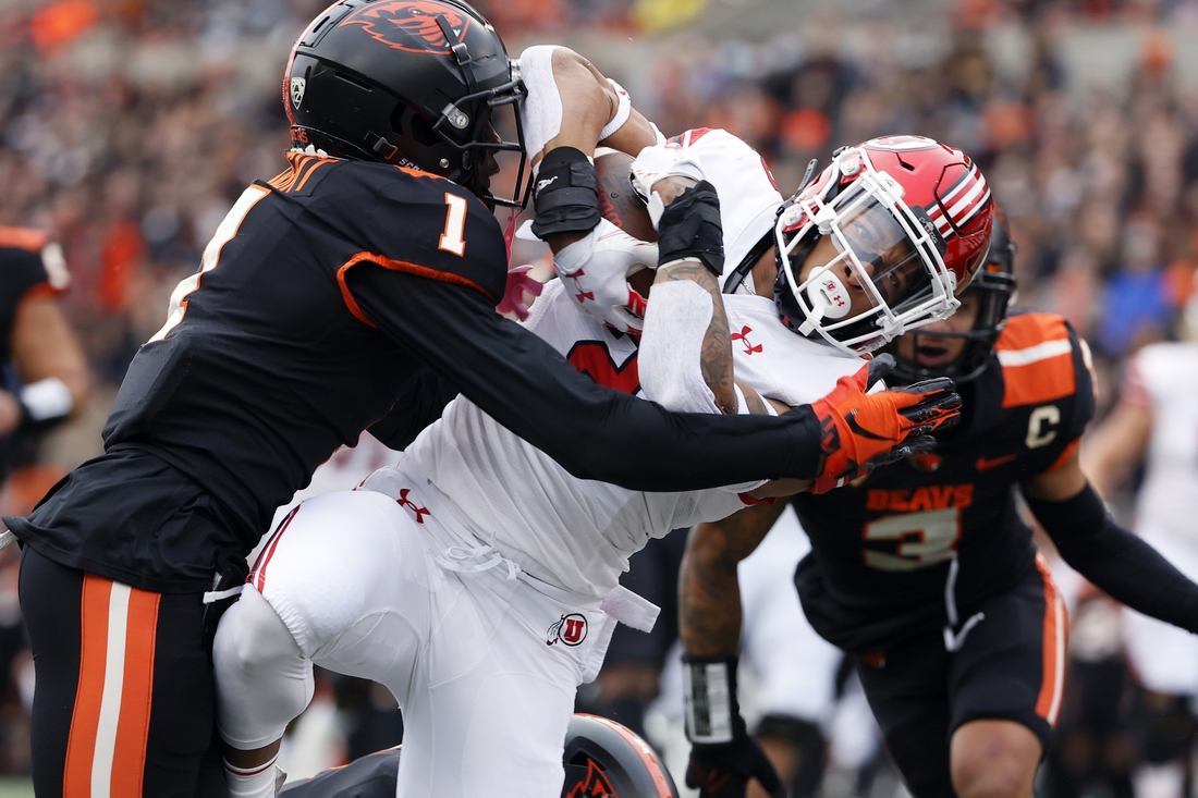 Oct 23, 2021; Corvallis, Oregon, USA; Utah Utes running back Micah Bernard (2) dives into the end zone to score a touchdown against Oregon State Beavers defensive back Rejzohn Wright (1) during the first half at Reser Stadium. Mandatory Credit: Soobum Im-USA TODAY Sports