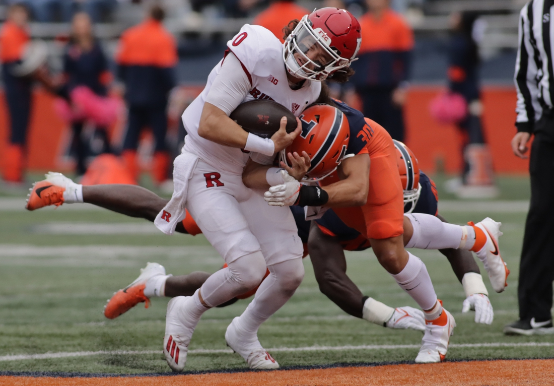 Oct 30, 2021; Champaign, Illinois, USA; Rutgers Scarlet Knights quarterback Noah Vedral (0) is tackled by Illinois Fighting Illini defensive back Sydney Brown (30) in the first half at Memorial Stadium. Mandatory Credit: Ron Johnson-USA TODAY Sports