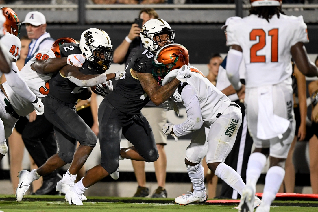 Aug 29, 2019; Orlando, FL, USA; UCF Knights running back Otis Anderson (2) runs the ball as Florida A&M Rattlers defensive lineman Renaldo Flowers Jr. (96) defends during the second half at Spectrum Stadium. Mandatory Credit: Douglas DeFelice-USA TODAY Sports