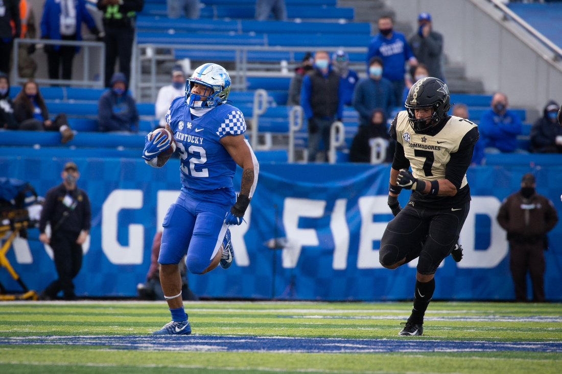 Nov 14, 2020; Lexington, Kentucky, USA; Kentucky Wildcats running back Chris Rodriguez Jr. (22) runs the ball down the field during the fourth quarter against the Vanderbilt Commodores at Kroger Field. Rodriguez Jr. wore jersey number 22 in honor of his teammate linebacker Chris Oats, who had a major emergency medical condition this past summer. Mandatory Credit: Arden Barnes-USA TODAY Sports