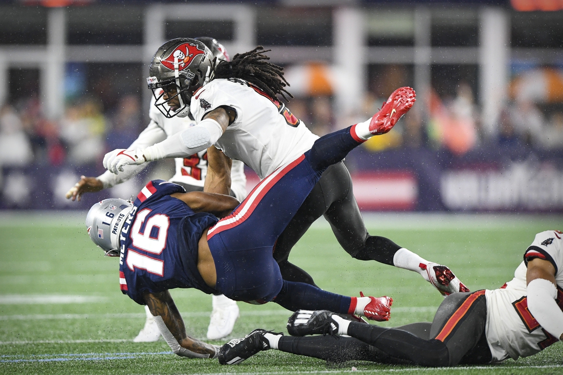 Oct 3, 2021; Foxboro, MA, USA; New England Patriots wide receiver Jakobi Meyers (16) is hit by Tampa Bay Buccaneers cornerback Richard Sherman (5) during the second quarter at Gillette Stadium.  Mandatory Credit: Brian Fluharty-USA TODAY Sports