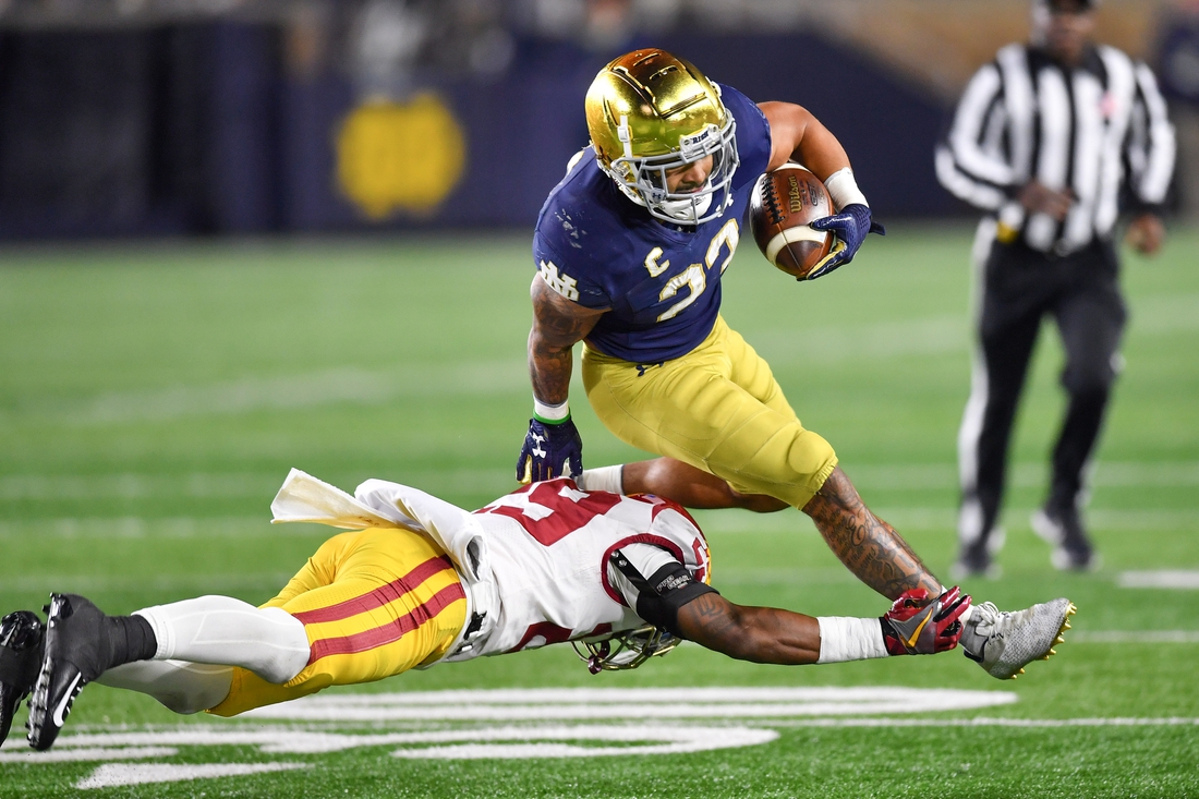 Oct 23, 2021; South Bend, Indiana, USA; Notre Dame Fighting Irish running back Kyren Williams (23) runs the ball as USC Trojans safety Xavion Alford (29) defends in the third quarter at Notre Dame Stadium. Mandatory Credit: Matt Cashore-USA TODAY Sports