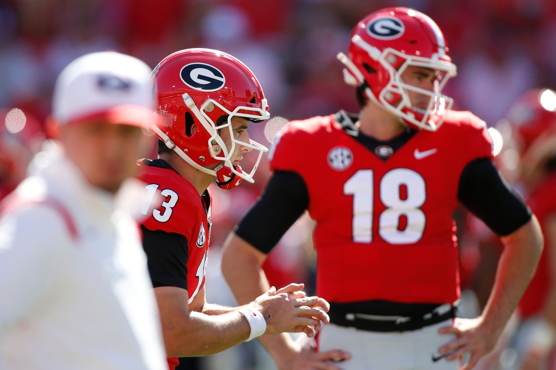 Georgia quarterback Stetson Bennett (13) warms up while Georgia quarterback JT Daniels (18) looks on before an NCAA college football game between Kentucky and Georgia in Athens, Ga., on Saturday, Oct. 16, 2021.

Syndication Online Athens