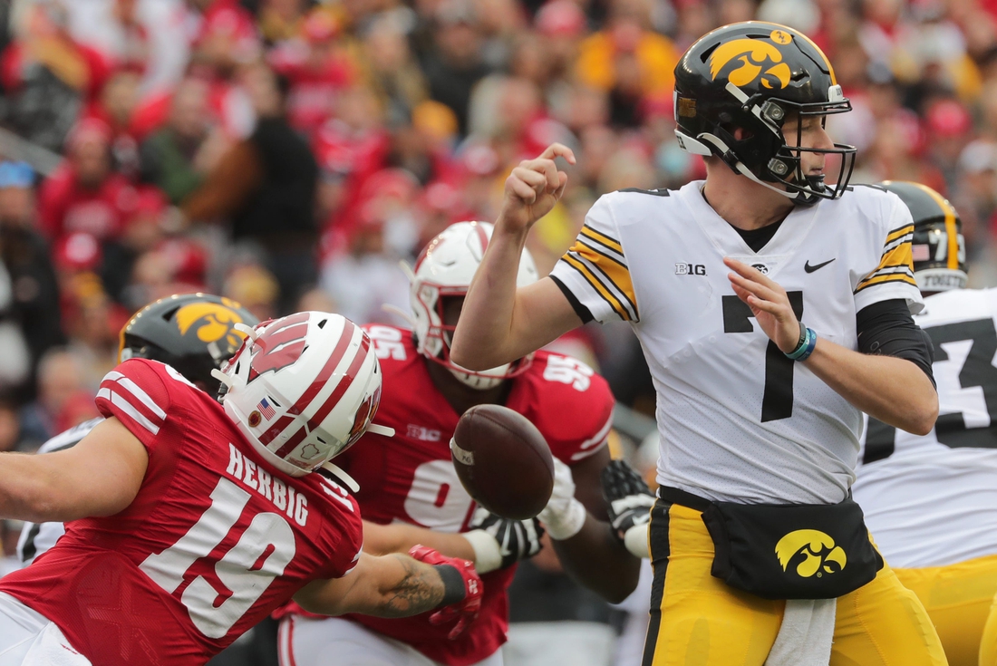 Wisconsin linebacker Nick Herbig (19) strips Iowa quarterback Spencer Petras (7) of the ball during the second quarter of their game on Saturday, Oct. 30, 2021, at Camp Randall Stadium in Madison. Wisconsin recovered the ball.

Mjs Uwgrid31 1 Jpg Uwgrid31