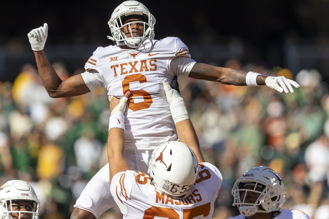 Oct 30, 2021; Waco, Texas, USA; Texas Longhorns wide receiver Joshua Moore (6) pulls celebrates a touchdown against the Baylor Bears with Texas Longhorns offensive lineman Jake Majors (65) in the first half of an NCAA football game at McLane Stadium. Mandatory Credit: Stephen Spillman-USA TODAY Sports