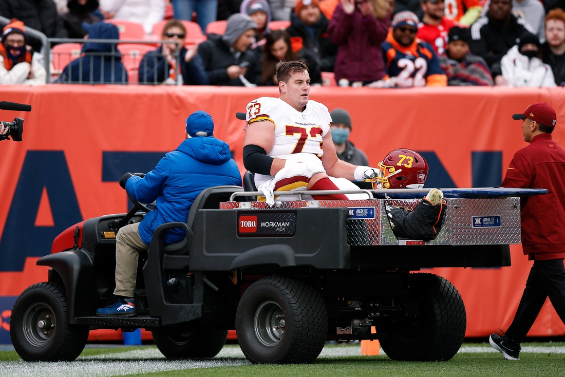 Oct 31, 2021; Denver, Colorado, USA; Washington Football Team center Chase Roullier (73) is carted off the field after a play in the second quarter against the Denver Broncos at Empower Field at Mile High. Mandatory Credit: Isaiah J. Downing-USA TODAY Sports