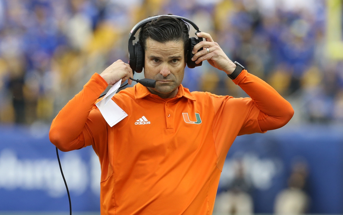 Oct 30, 2021; Pittsburgh, Pennsylvania, USA;  Miami Hurricanes head coach Manny Diaz puts his headset on against the Pittsburgh Panthers during the fourth quarter at Heinz Field. Mandatory Credit: Charles LeClaire-USA TODAY Sports