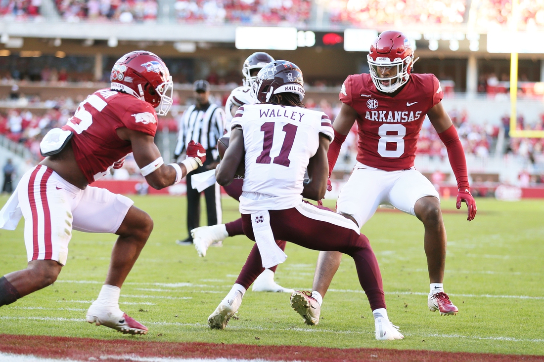Nov 6, 2021; Fayetteville, Arkansas, USA; Mississippi State Bulldogs wide receiver Jaden Walley (11) catches a pass for a touchdown during the second quarter as Arkansas Razorbacks defensive back Jayden Johnson (8) looks on at Donald W. Reynolds Razorback Stadium. Mandatory Credit: Nelson Chenault-USA TODAY Sports