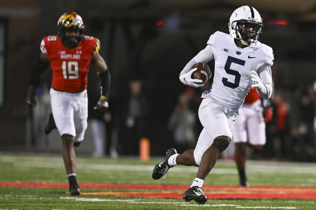 Nov 6, 2021; College Park, Maryland, USA; Penn State Nittany Lions wide receiver Jahan Dotson (5) runs a fourth quarter touchdown as Maryland Terrapins linebacker Ahmad McCullough (19) defends  at Capital One Field at Maryland Stadium. Mandatory Credit: Tommy Gilligan-USA TODAY Sports