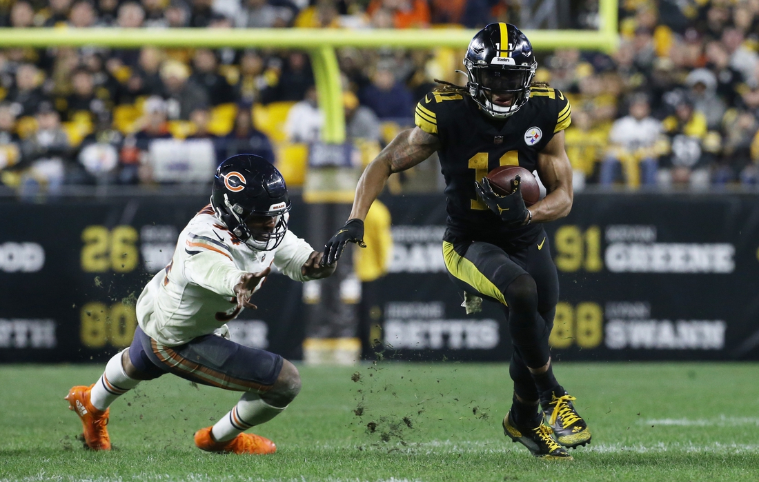 Nov 8, 2021; Pittsburgh, Pennsylvania, USA;  Pittsburgh Steelers wide receiver Chase Claypool (11) runs after a catch against Chicago Bears outside linebacker Robert Quinn (94) during the fourth quarter at Heinz Field. Pittsburgh won 29-27.  Mandatory Credit: Charles LeClaire-USA TODAY Sports