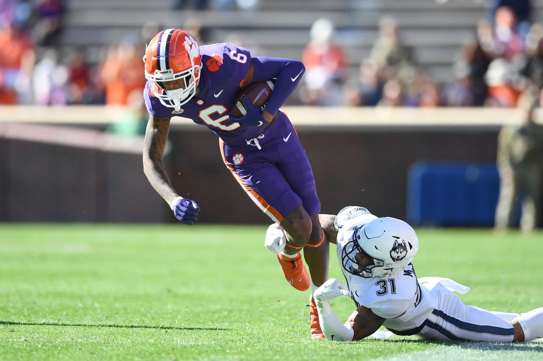 Nov 13, 2021; Clemson, South Carolina, USA; Clemson Tigers wide receiver E.J. Williams (6) is tackled by Connecticut Huskies defensive back Malik Dixon (31) during the first quarter at Memorial Stadium. Mandatory Credit: Adam Hagy-USA TODAY Sports