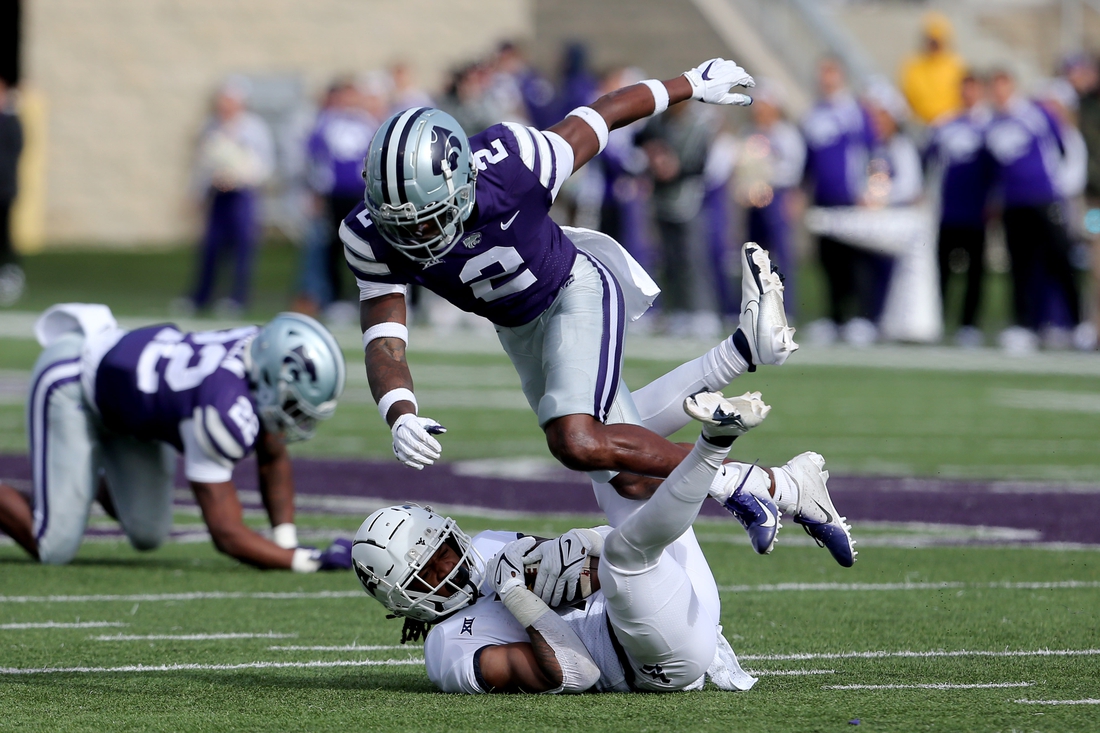 Nov 13, 2021; Manhattan, Kansas, USA; West Virginia Mountaineers wide receiver Winston Wright Jr. (1) is tackled by Kansas State Wildcats defensive back Russ Yeast (2) during the first quarter at Bill Snyder Family Football Stadium. Mandatory Credit: Scott Sewell-USA TODAY Sports