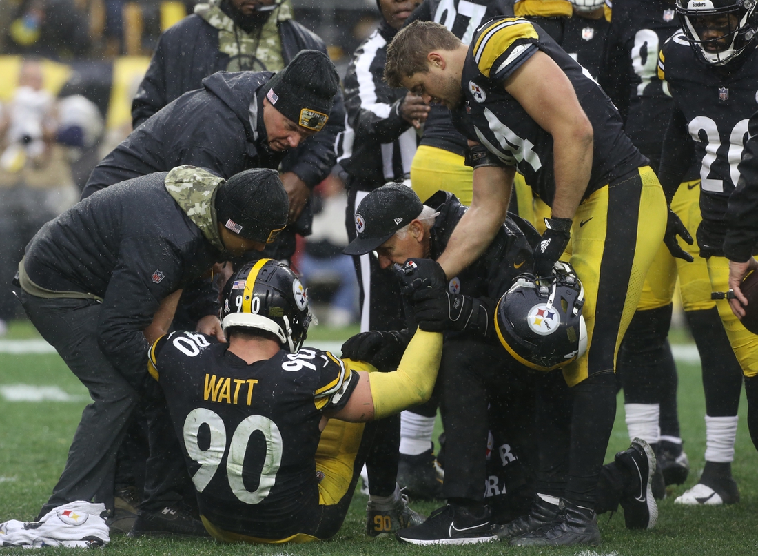 Nov 14, 2021; Pittsburgh, Pennsylvania, USA;  Pittsburgh Steelers team trainers attend to outside linebacker T.J. Watt (90) as his brother fullback Derek Watt (44) looks on during the third quarter against the Detroit Lions at Heinz Field. The game ended in a 16-16 tie. Mandatory Credit: Charles LeClaire-USA TODAY Sports